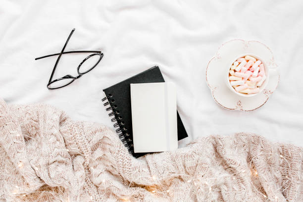 istock Home office on bed with warm plaid. Mockup card. Flat lay, top view 1277227271