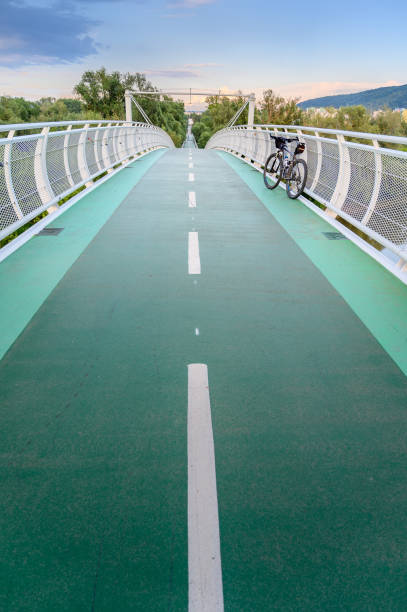 Empty bicycle bridge (called âFreedom bridgeâ) connecting two countries Slovakia and Austria during sunset (Bratislava, SLOVAKIA)