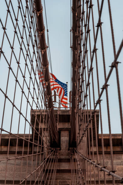 istock Waving American flag on the Brooklyn Bridge 1277228424
