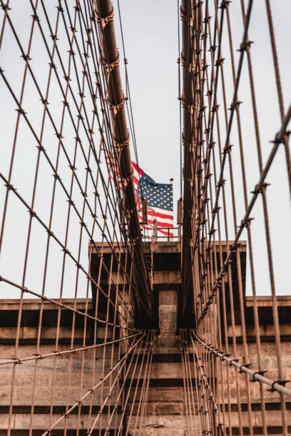 istock Waving American flag on the Brooklyn Bridge 1277228431