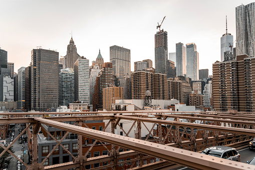 Manhattan Skyline from the Brooklyn Bridge, with bridge structure in the foreground.