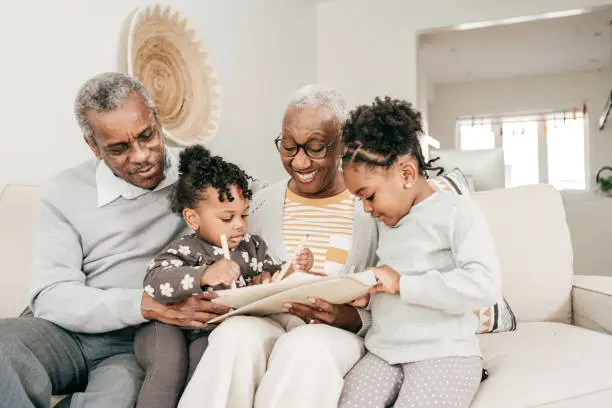 Photo of Grandmother and grandfather with grandkids at home