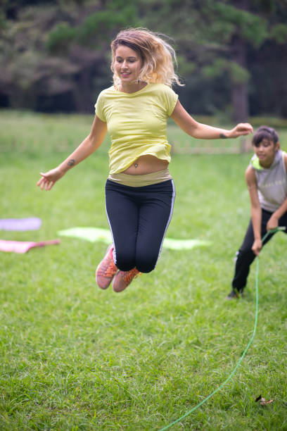 istock Mother playing jumping rope with daughters 1277236175
