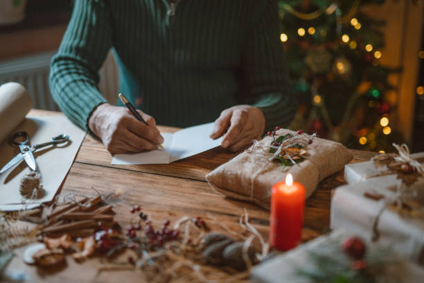 istock Man Is Typing A Christmas Greeting Card And Packaging Gifts Only With Biodegradable Materials 1277238344