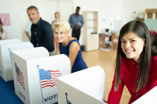 Diverse people voting at election center