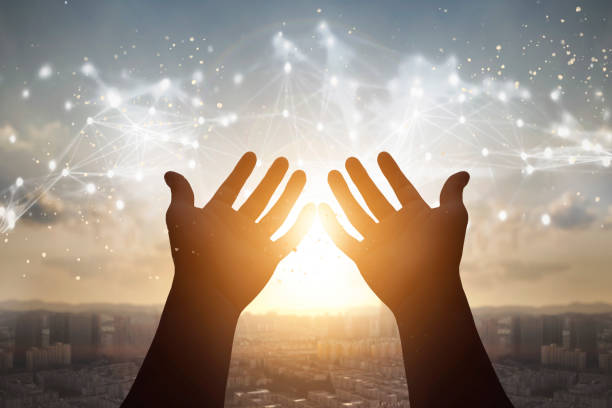 istock Technology concept: Silhouette many people raised hands over city sunset background 1277245017