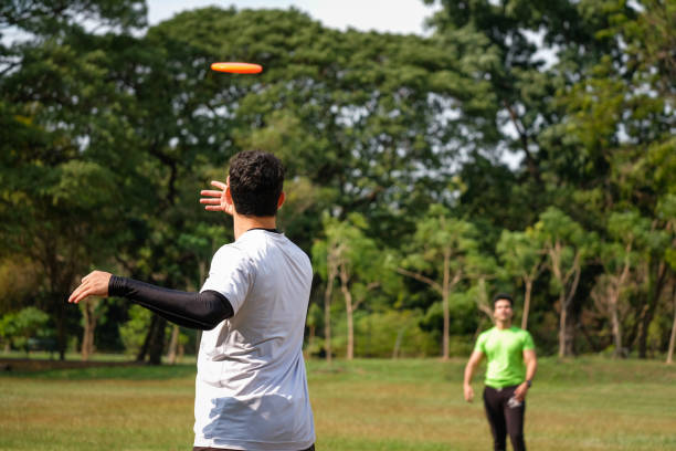 istock Young man playing frisbee in the park 1277253934