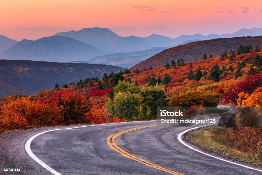 Winding mountain road with fall colors Winding mountain road and autumn landscape with vibrant fall colors near Gunnison, Colorado. Autumn Stock Photo