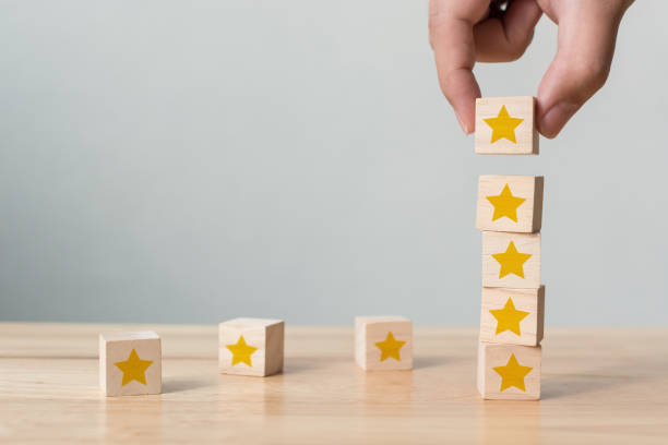 istock Hand building wood block cube stacking on top with five star shape. The best excellent business services rating customer experience concept 1277262866