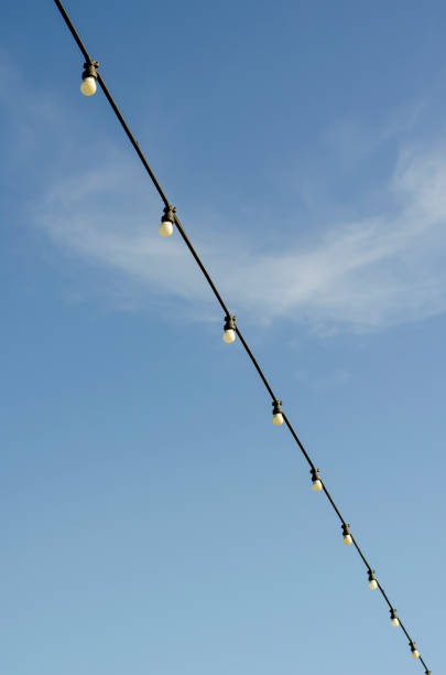 istock Garland with light bulbs on a background of blue sky. 1277266563