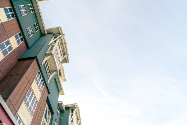 istock Residential building exterior viewed from below with cloudy sky background 1277269143