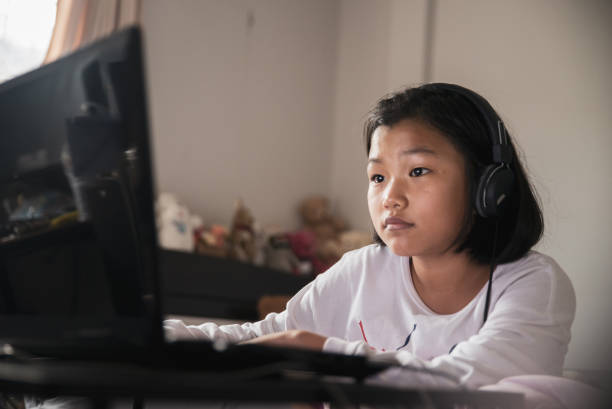 istock Asian children using laptop to learning and doing homework at home. Happy Thai Students study online for study to the exam. Education concept. 1277269949