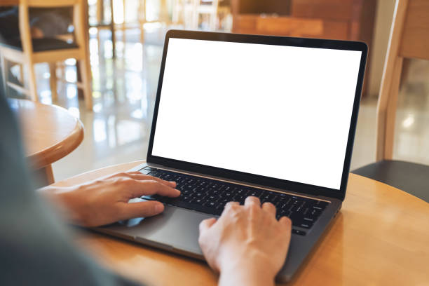 istock a woman using and typing on laptop computer keyboard with blank white desktop screen on wooden table 1277270707