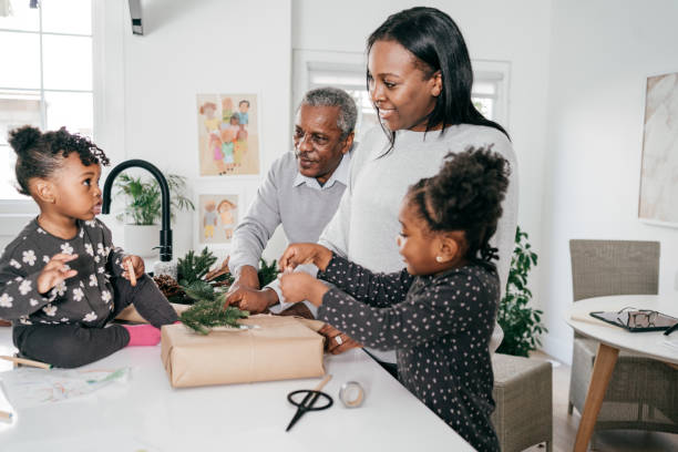 istock Family in the kitchen wrapping presents 1277270734