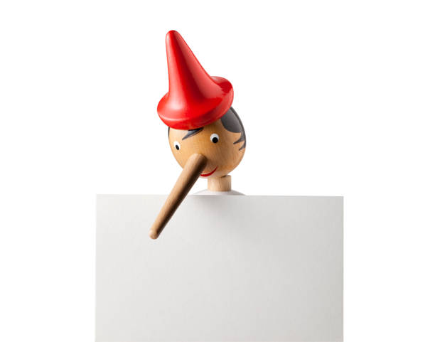 istock Lie. Pinocchio with blank placard. 1277270780