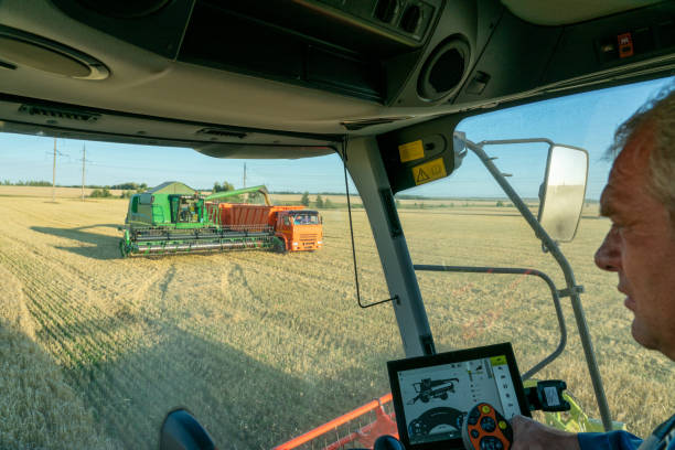 istock the machine operator at the helm of a modern combine harvester harvests grain 1277271417
