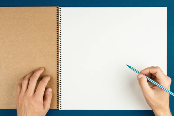 istock man hands hold opened notebook pages with pencil 1277273060