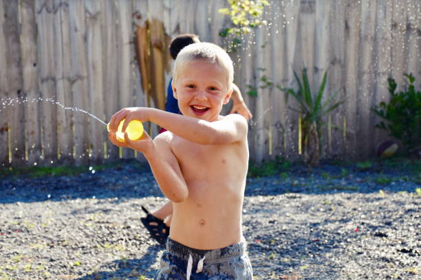 Millennial parents playing with kids in water