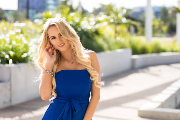 Blonde Woman In Blue Formal Dress Blonde Woman In Blue Formal Dress In Parkland Setting 'formal dress' stock pictures, royalty-free photos & images