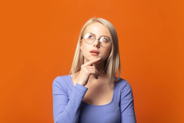istock Cute blonde in blue blouse and glasses 1277277091