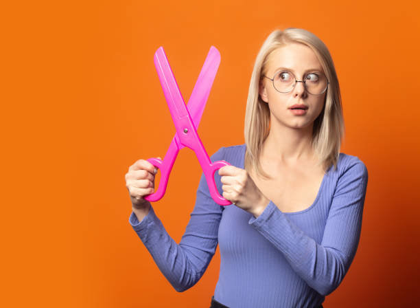 istock Cute blonde in blue blouse with big scissors 1277277105