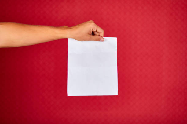 istock Closeup courier hand holding grocery paper bag, delivery service 1277278023