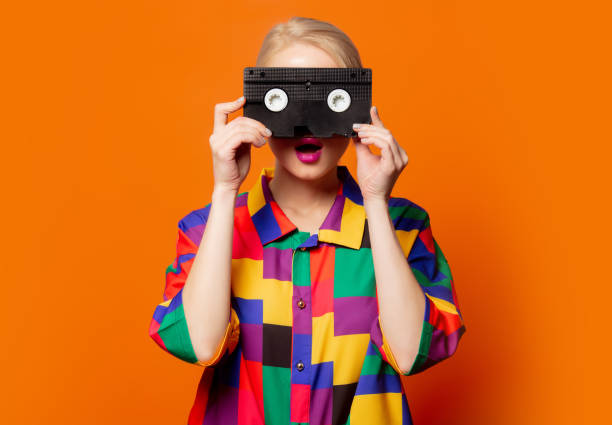 istock Style blonde in 90s clothes with VHS cassette 1277278484