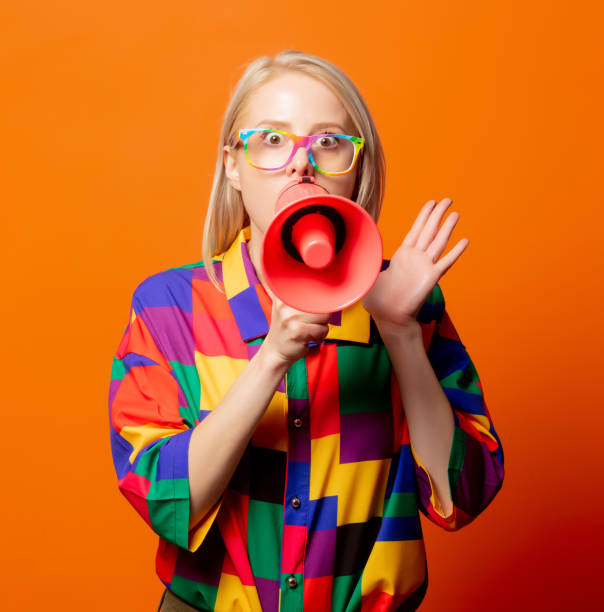 istock Style blonde in 90s clothes and rainbow glasses with megaphone 1277278528