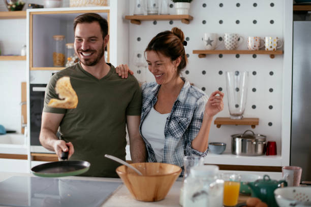 istock Young couple making pancakes at home 1277279532