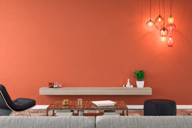 Empty nostalgic living room with gray sofa, lounge chair, pouffe, table and decoration in front of brick orange plaster wall