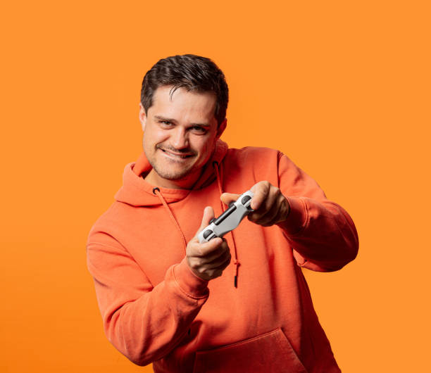 funny guy in orange hoodie with game controller