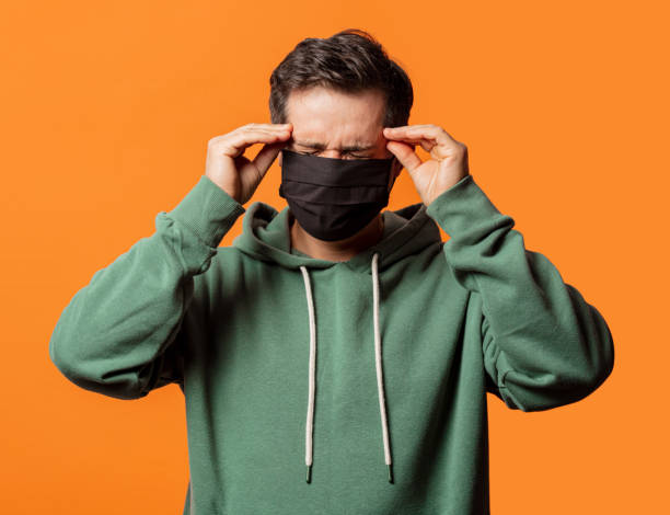 istock guy in face mask and green hoodie 1277279847