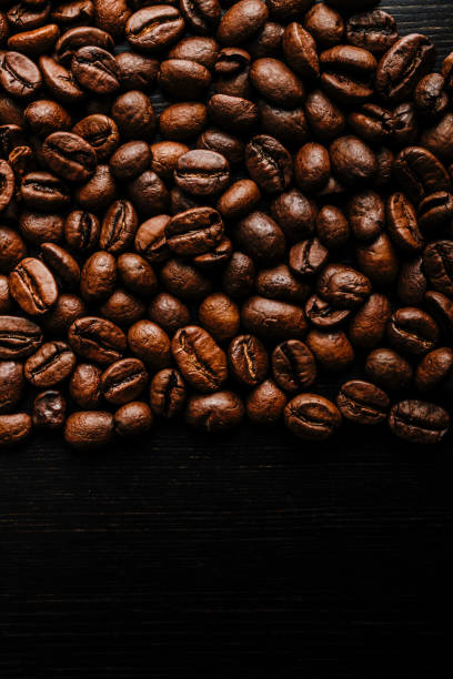 istock Coffee beans on wooden background. 1277280024