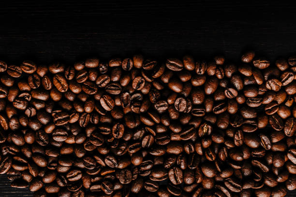 istock Coffee beans on wooden background. 1277280025