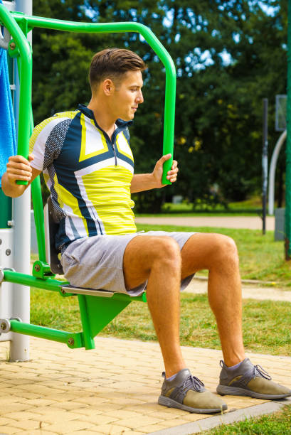 istock Man flexing arm in outdoor gym 1277281007