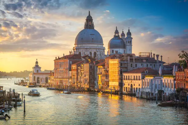 Photo of Venice grand canal, Santa Maria della Salute church landmark at sunrise. Italy