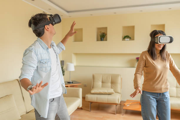 istock Excited Young Couple is Spending a Great Time while Playing Video Games with VR Glasses. 1277282142