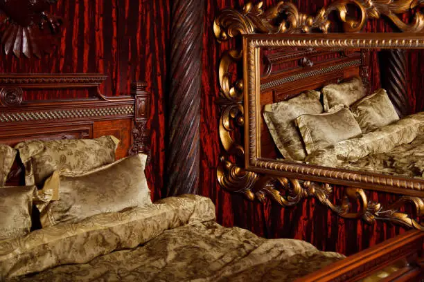 Photo of Luxury bedroom in medieval style with art Deco elements and large mirror