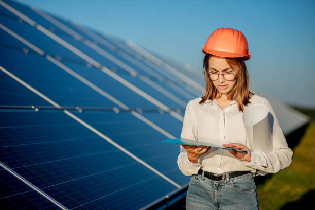 istock Inspector Engineer Woman Holding Digital Tablet Working in Solar Panels Power Farm, Photovoltaic Cell Park, Green Energy Concept 1277285232