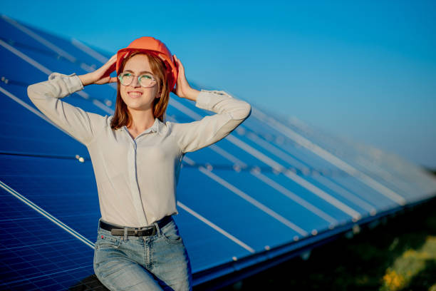 istock Beautiful young engineer standing near solar panels outdoors, Green Energy Concept 1277285402