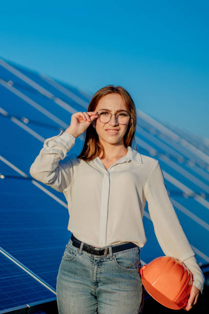 istock Beautiful young engineer standing near solar panels outdoors, Green Energy Concept 1277285405