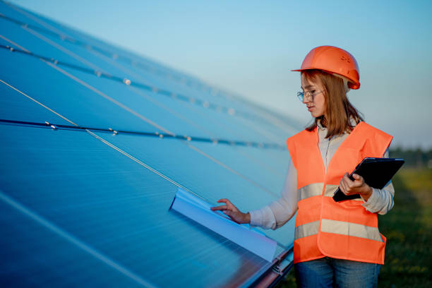 istock Inspector Engineer Woman Holding Digital Tablet Working in Solar Panels Power Farm, Photovoltaic Cell Park, Green Energy Concept 1277285486