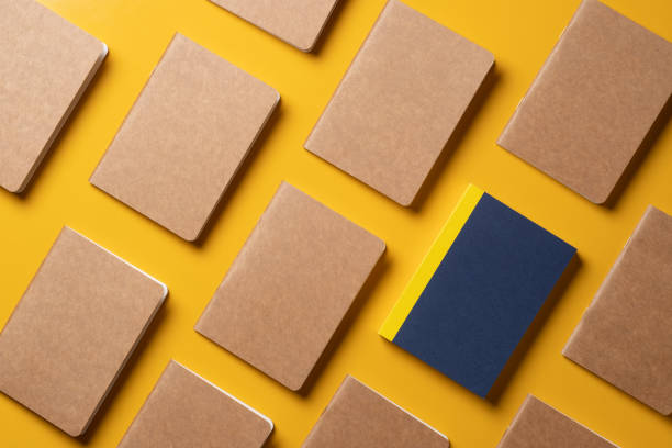 istock creativity content marketing concept,.top view of blue notebook align in pattern on yellow table background.mockup for advertise content online.unique idea 1277285826