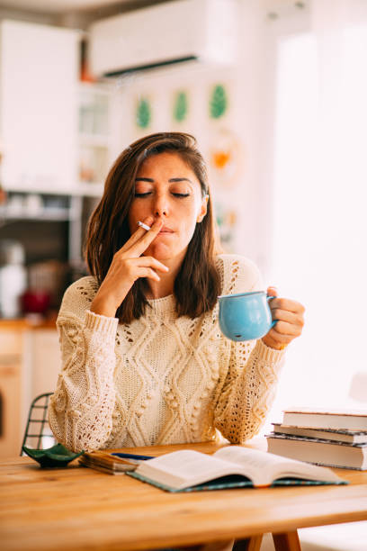 istock Smoking Woman is Reading a Book 1277286627