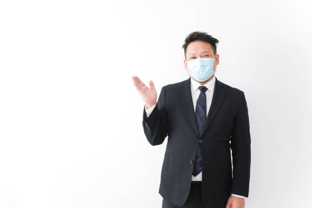 istock Businessman in suit with a mask 1277286738