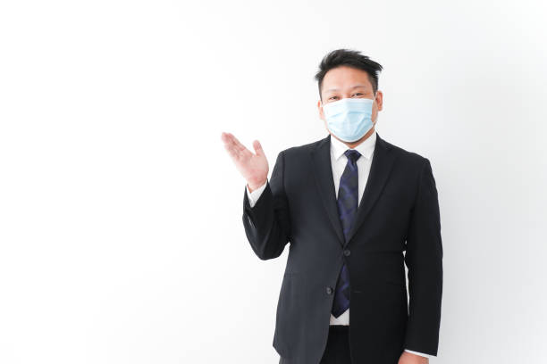 istock Businessman in suit with a mask 1277286741