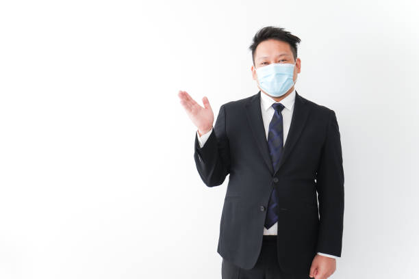 istock Businessman in suit with a mask 1277286742