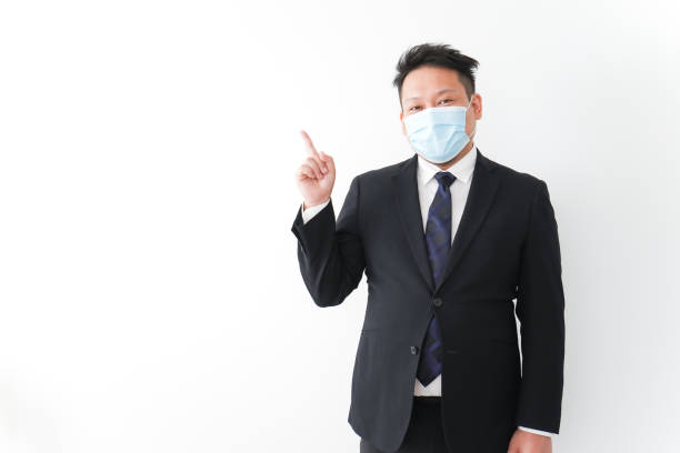 istock Businessman in suit with a mask 1277286744