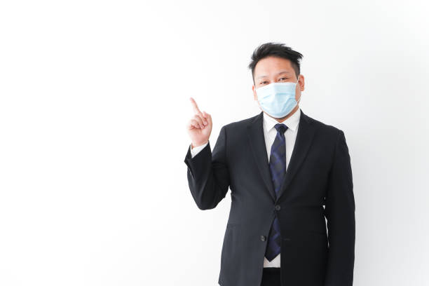 istock Businessman in suit with a mask 1277286748