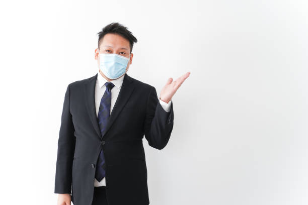 istock Businessman in suit with a mask 1277286749